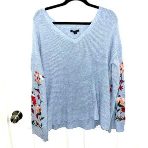 American Eagle size M blue v neck sweater with floral embroidery on the sleeves